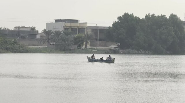Basra, Iraq - November 8, 2023: Small boat on calm river during peaceful sunset