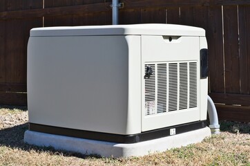Standby home generator set in residential backyard emergency backup power supply.	
