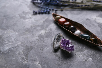 Set of chakra stones, crystals and flowers on grunge background