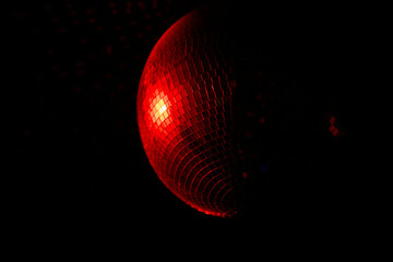A Disco Ball Shining Red Light, Creating an Energetic Atmosphere Perfect for Celebrating