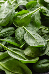 Fresh green spinach leaves with drops of water