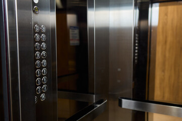 The modern elevator has a stylish control panel and elegant wood accents for function and beauty