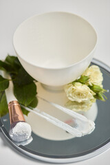 An Elegant Spa Setup Featuring a Beautiful Bowl, Fresh Flowers, and Essential Skincare Tools