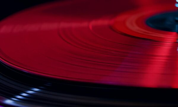 Red vinyl record spinning on a turntable