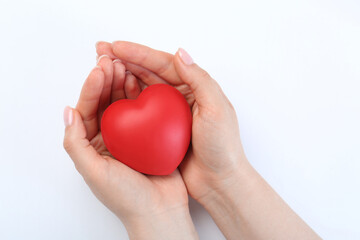 Woman holding red heart on white background, closeup