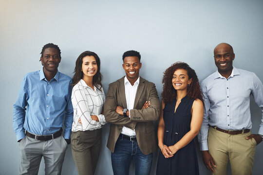 Business people, portrait and diversity with about us by background, happy realtor group and confident in profession. Real estate agent team, arms crossed and employees smile for career pride