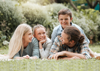 Fototapeta premium Family, relax and garden hug for love, outdoor childcare and bonding together in Scotland. Parents, countryside and embrace children for security in relationship, vacation picnic and holiday trip