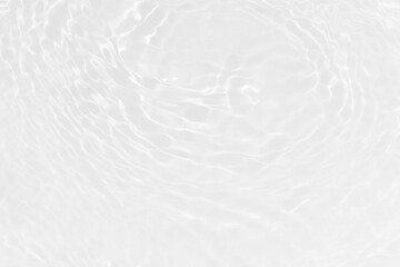 White water with ripples on the surface. Defocus blurred transparent white colored clear calm water surface texture with splashes and bubbles. Water waves with shining pattern texture background.