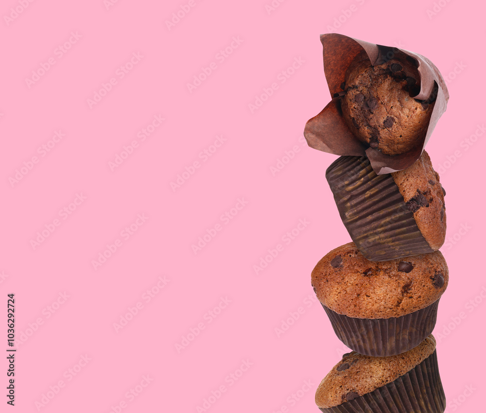 Sticker Stacked tasty chocolate chip muffins on pink background. Space for text