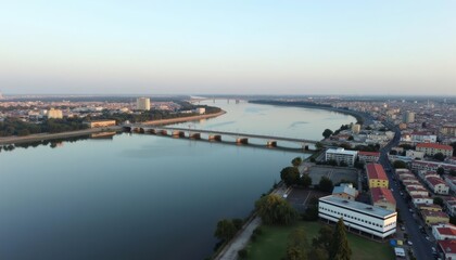 Naklejka premium Aerial view of a city by the river at sunset
