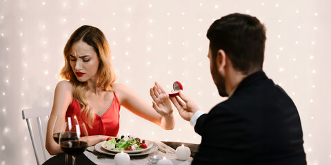 She Said No. Young Woman Refusing Marriage Proposal From Boyfriend, Gesturing Stop To Offered Engagement Ring On Date In Restaurant, Selective Focus