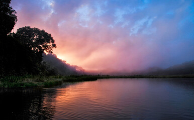 Sunrise on Amazon Jungle River, Peru. Misty morning in the Jungle