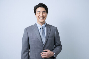 Upper half of a handsome man in a business suit.