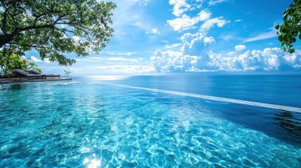 A serene infinity pool overlooking a tranquil ocean under a bright blue sky.