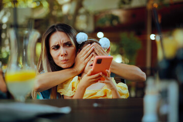Mother Covering Daughter Eyes Preventing her to Watch social media. Parent restricting the internet...