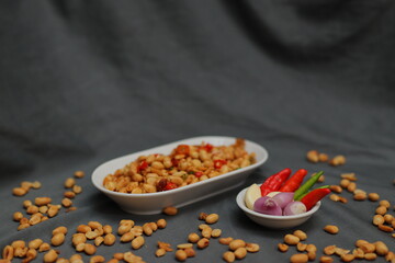 Nuts and spices chili and onion on black background for product, educational and other purposes