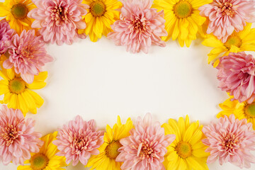 Yellow flower and pink flower frame border on a white background with copyspace