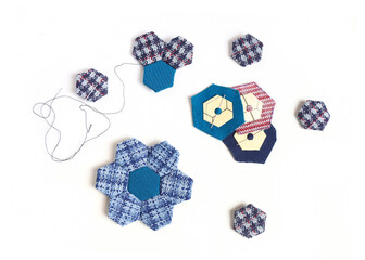 Quitting accessaries and quilt blocks for making a handmade hexagon blanket.
