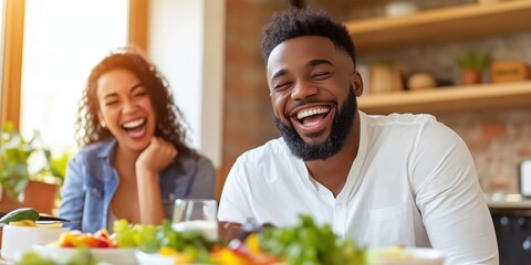 A joyful couple shares a lighthearted moment filled with laughter while enjoying a healthy meal at home