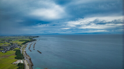 Offshore wind turbines, breakwaters, windbreak forests, etc. on the coastline facing Toyama Bay in Japan