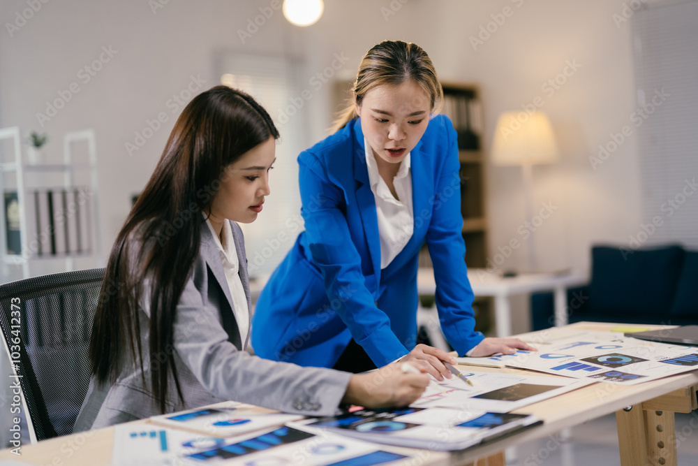 Aufkleber two young businesswomen collaborate on financial analysis and growth strategies in a busy office, di