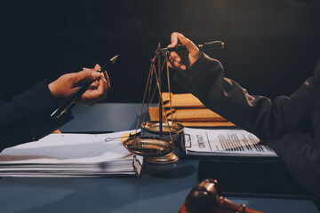 Fototapeta premium Judge gavel with Justice lawyers having team meeting at law firm background. Concepts of Law and Legal services.