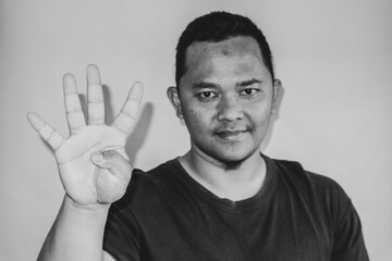 A man is raising his index finger to count four