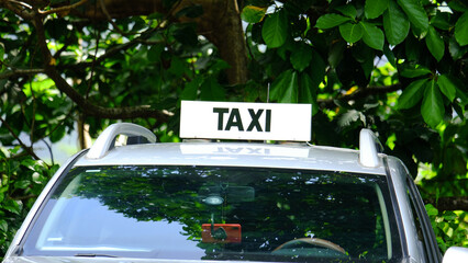 Taxi sign on car at popular tourism spot of Belvedere Lookout on Moorea Island in French Polynesia, South Pacific