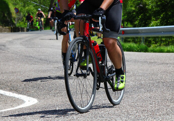 Fototapeta premium cyclist riding a racing bike viewed from below during a cycling competition on the road