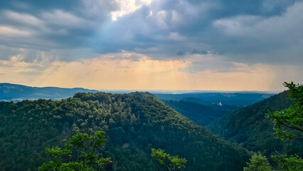 Naklejka premium Scenic view of Schloss Herberstein in Stubenberg, Styria, Austria. Historic castle nestled amidst lush green forests. Surrounding rolling hills covered in dense foliage. Seclusion and tranquility