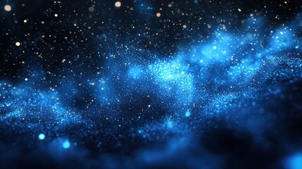Obraz premium A mesmerizing view of a starry night sky filled with shimmering blue cosmic dust illuminating the vast darkness of outer space