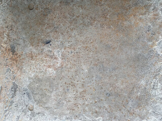 Close-up of weathered metal surface with dirt, rust, and visible rivets, rough texture and aged appearance. 