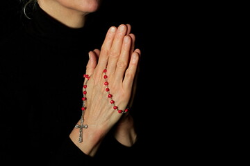 praying to god with hands together with crucifix cross on black background with people stock photo stock image