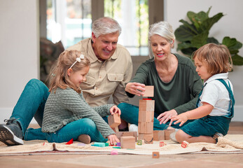 Playing, children and grandparents in house, building blocks and bonding of family, growth and development. Games, kids and learning with toys, people and smile in living room, floor and fun in home