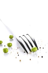 Fork has put teeth into a pea. Salt and pepper sprinkled over isolated on white background