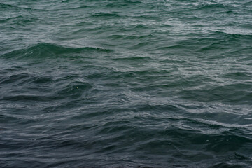 Fototapeta premium Textural waves at sunset in the sea