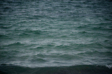Fototapeta premium Textural waves at sunset in the sea