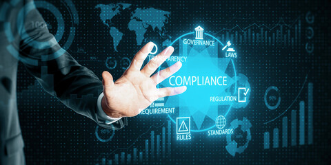 Man hand interacting with a digital compliance interface featuring neon blue data and regulatory icons in a business context.
