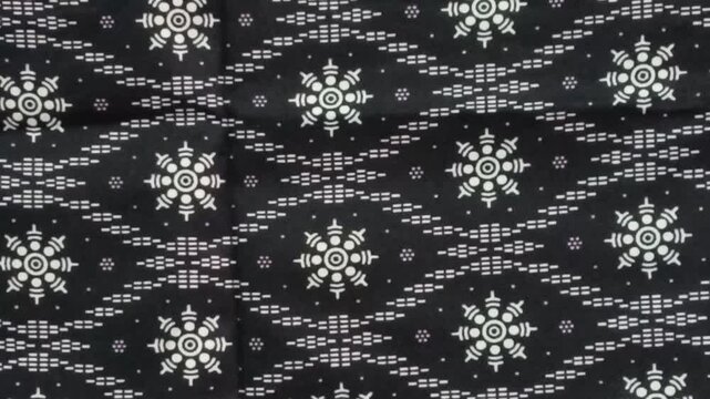 texture of sarawak black batik print fabric striped background.Malaysian culture batik cloth. photo taken in malaysia
