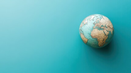 Fototapeta premium Earth globe icon on a cyan background, emphasizing environmental responsibility and international collaboration.