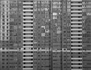 Apartment block building with a lot of windows. Textured and background structured design. Life in big city.
