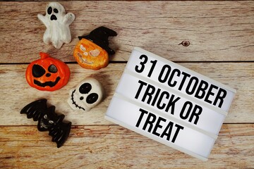31 October Halloween with Trick or Treat with Halloween Element on wooden background