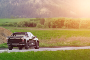 Fototapeta premium Modern Japanese made pickup on a road nature background