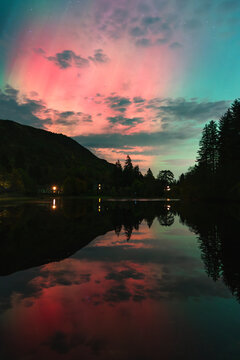 Orange and Green Aurora Reflect on Loch Ard