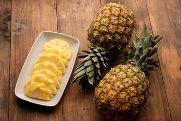 pineapple slices on a black ceramic plate. Ananas comosus. tropical fruit.