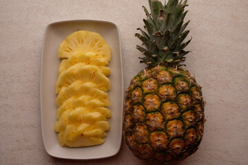 pineapple slices on a white ceramic plate. Ananas comosus. tropical fruit.