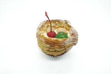 cream puff or choux pastry filled with cherries isolated on white background