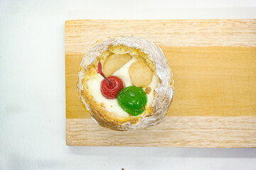 cream puff or choux pastry filled with cherries isolated on white background