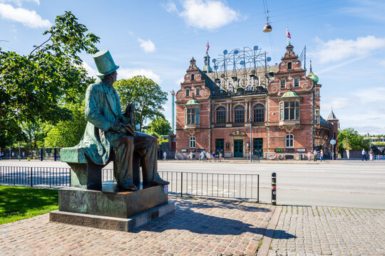Copenhagen, Denmark - July 18, 2024: Statue of Danish author Hans Christian Andersen by Henry Luckow-Nielsen, erected in 1965 on the City Hall square opposite the H.C. Andersen Castle (Tivoli Castle).