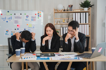 The Weight of Responsibility: A diverse business team grapples with a challenging situation, their...